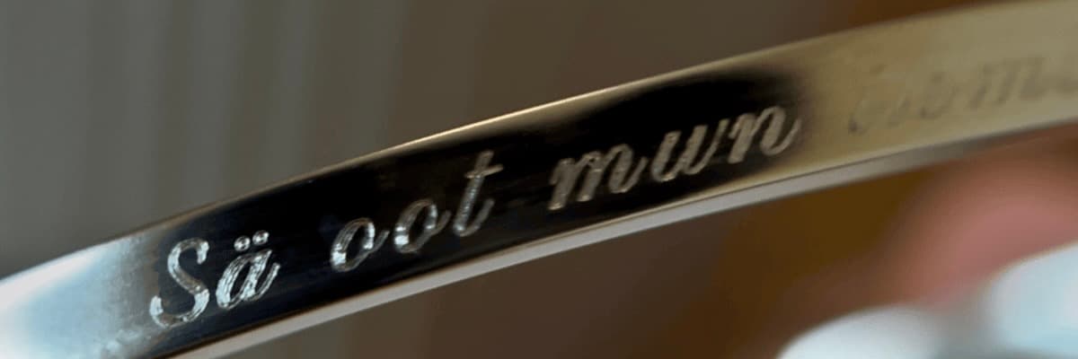 Close-up of an engraving on a gold cuff bracelet