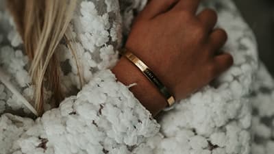 Engraved cuff bracelets worn on a wrist